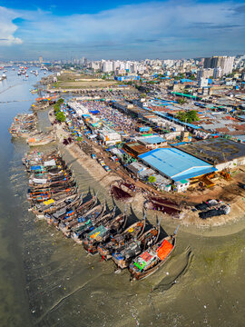 Boats anchored along the Karnaphuli River near a busy fish market in Bangladesh