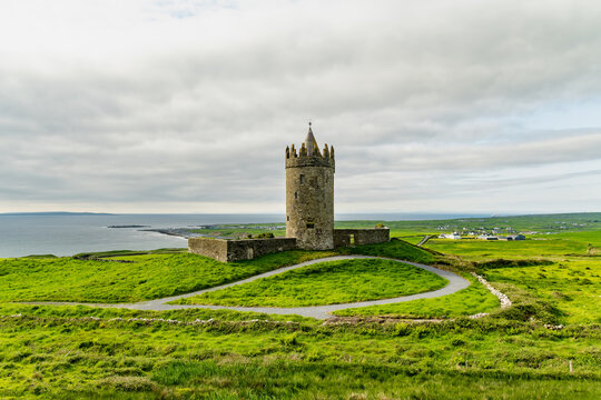 Doonagore Castle overlooking the Atlantic Ocean near Doolin, County Clare, Ireland. Historic 16th century tower house on the Wild Atlantic Way.