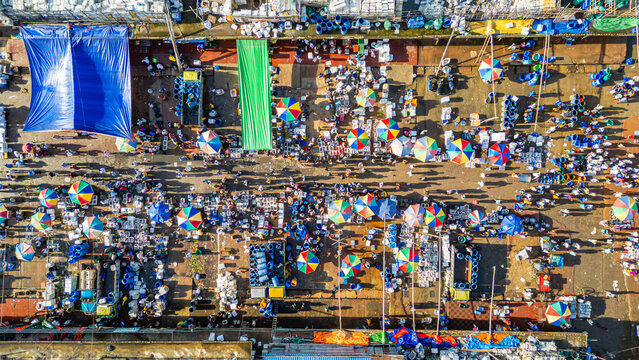 Aerial view of bustling fish market filled with vendors and shoppers in Chittagong, Bangladesh during busy market hours