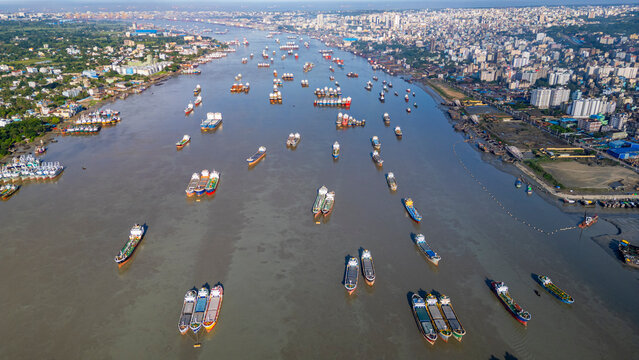 Anchoring boats gather on the Karnaphuli River near the fish market in Chittagong, Bangladesh during the daytime