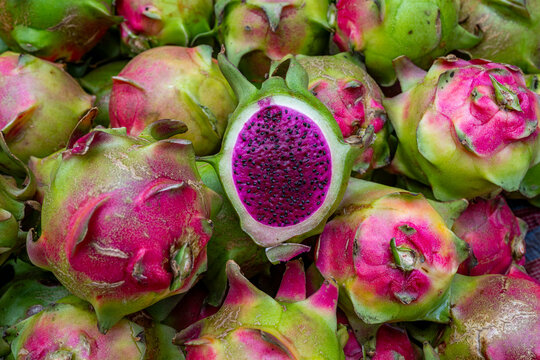Dragon fruit displayed in a vegetable market in Dhaka, Bangladesh during daytime hours with vibrant colors