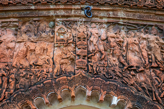 Historic carvings on the wall of Puthia Rajbari Complex showing intricate designs and scenes of daily life in Bangladesh