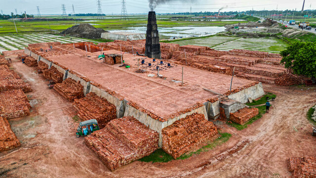Brick manufacturing process at a factory with stacks of bricks ready for use in Dhaka, Bangladesh