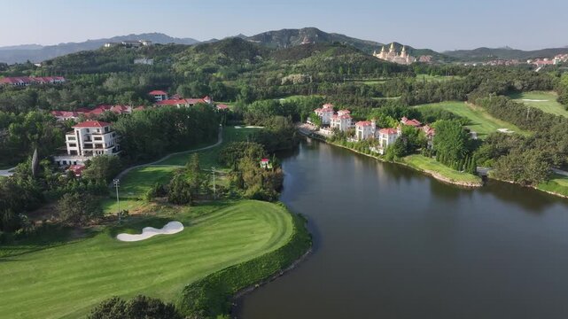 Lakeside golf course with European-style villas surrounded by green hills and dense forests