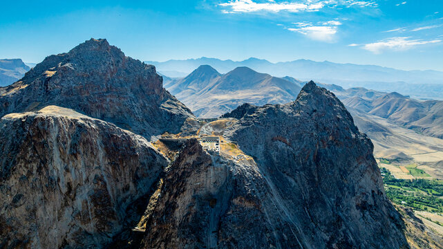 View of Alinja castle atop a mountain in Azerbaijan showcasing the rugged terrain and distant hills