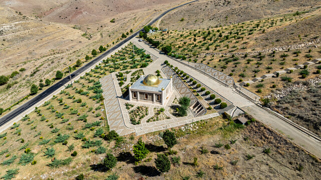 Aerial view shows mosque located below a castle in Nakhchivan, Azerbaijan surrounded by landscape and trees