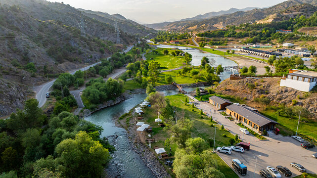 View of Hakari river flowing through mountain resort in Lachin, Qarabaqh with greenery and roads visible
