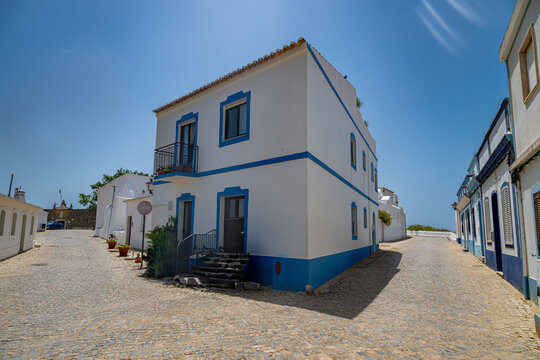Historic building and cobblestone street in Cacela Velha Portugal showcasing traditional architecture and local charm