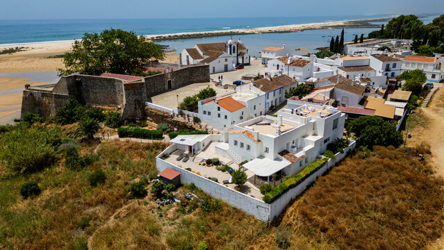 Aerial view of the historic village Carela Velha in Vila Nova de Cacela, Faro, Portugal with the coastline in the background