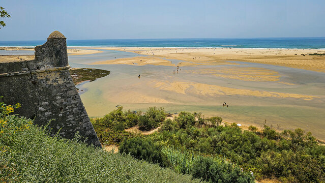 Fort overlooks the sandy beach and tidal flats near the village Cacela Velha in Portugal on a sunny day