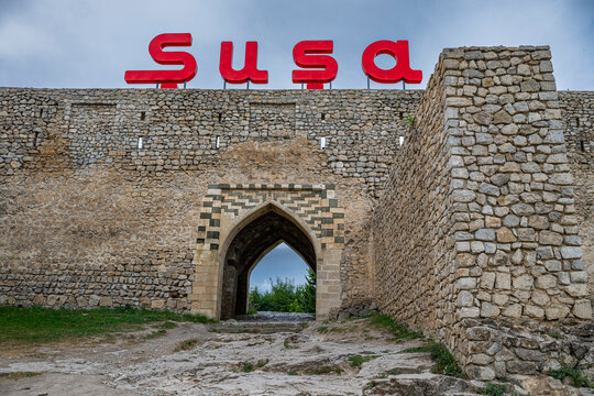 Visit to the Citadel of Shusha in Qarabaqh Azerbaijan with stone walls and a colorful sign above the entrance