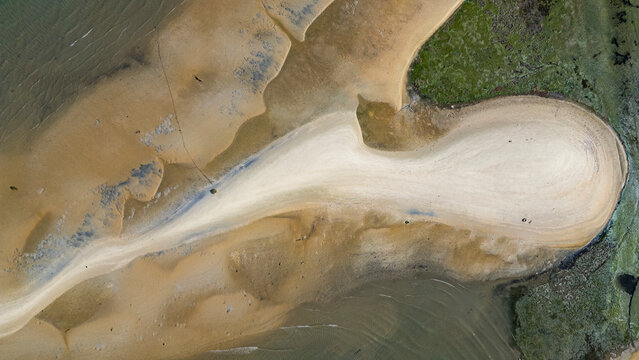 Aerial view showcasing sandy wetlands and tidal patterns in Olhao region of Algarve, Portugal