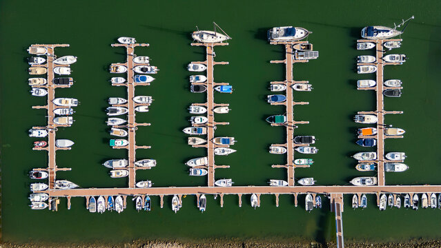 Small ship harbour in Algarve shows numerous boats arranged neatly along docks in Olhao