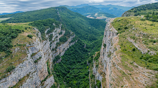 Majestic canyon view from above in Qarabaqh with surrounding hills and valleys under cloudy skies