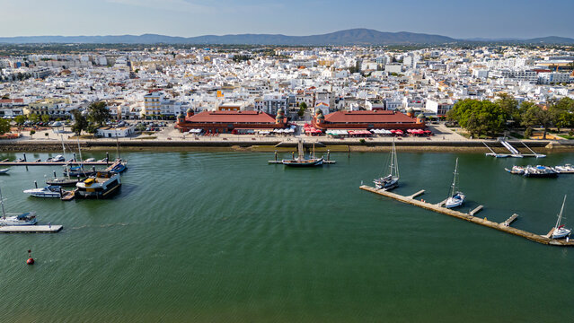 Sailing boat located in front of the ancient market of Olhao in Algarve Portugal during a sunny day