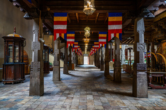 Explore the architecture and atmosphere of the Temple of the Tooth in Kandy, Sri Lanka with vibrant flags hanging in the hall