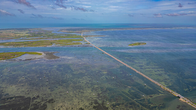 Exploring waterway and landscape of Jaffna in Sri Lanka during daytime with clouds in sky