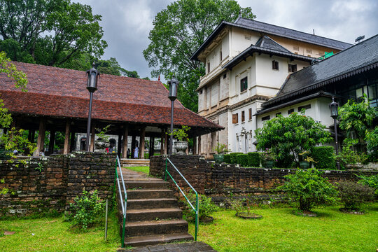 Visitors explore the Temple of the Tooth in Kandy, a sacred site in Sri Lanka surrounded by greenery and rich history