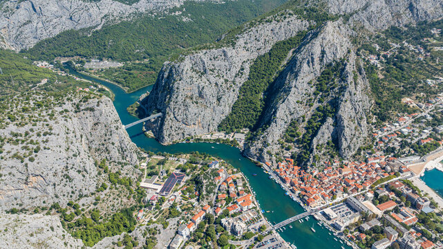 View of the town and river from above, showing the rock landscape and buildings below in Omis, Croatia