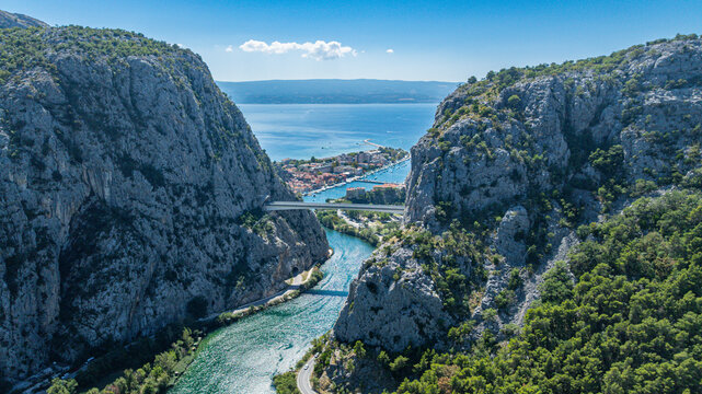 Explore Omis from above, featuring cliffs, a river, and a distant seaside town in Croatia&rsquo;s natural landscape
