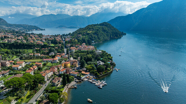 Scenic view of Enno with lake, boats, and mountains under clear sky in Croatia by Lake Como