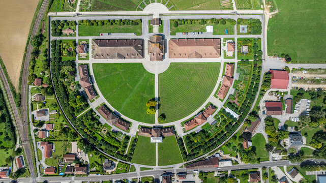 Views of the Royal Saltworks at Arc-et-Senans in France showing the unique circular layout and surrounding greenery from above