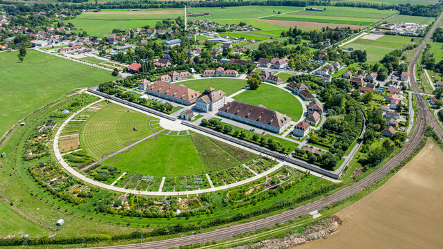 View of the Royal Saltworks at Arc-et-Senans, France showcasing historic architecture and surrounding landscape