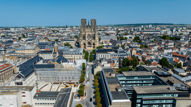 Aerial view showing Notre Dame cathedral of Reims surrounded by city buildings in France during daylight