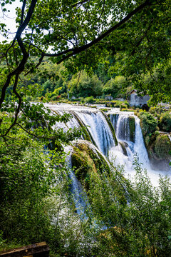 Strbacki buk waterfall flows through green landscape in Bosnia and Herzegovina during sunny weather