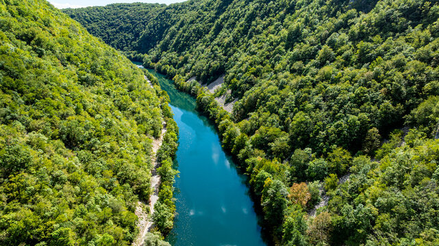 Aerial view of Una river winding through green hills in Una National Park in Bosnia and Herzegovina