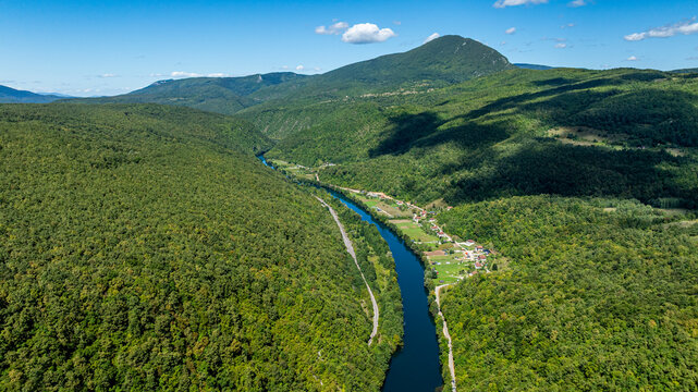 Aerial view shows the Una river winding through forests in national park in Bosnia and Herzegovina