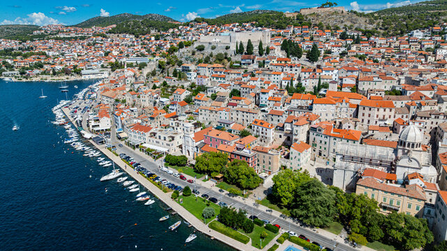 Aerial view shows colorful buildings along the waterfront in Sibenik Croatia showcasing the city's layout and architecture