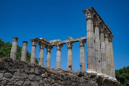 Explore the remains of Roman Temple of Evora in Portugal with ancient columns and blue sky