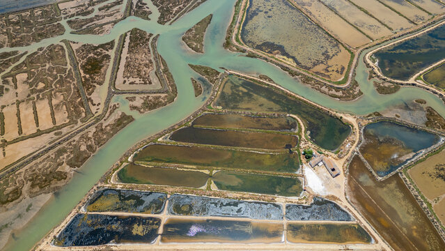 Aerial view showing saltpans, water channels, and land features in Algarve region of Portugal