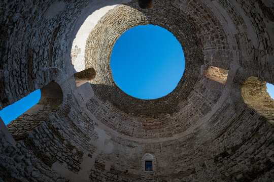 Exploration of ancient architecture in cellars showing circular structure and blue sky in Croatia