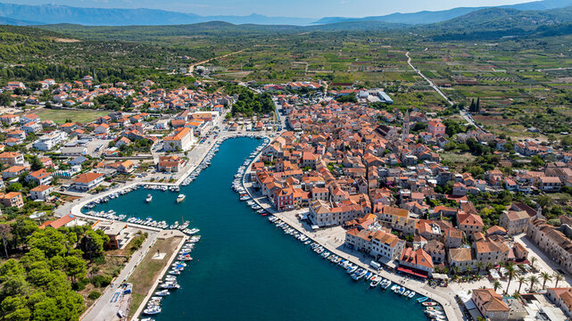 Explore the old town of Stari Grad and its harbor set against the backdrop of Stari Grad Plain in Hvar, Croatia