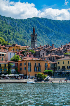 Varenna offers views of lakeside buildings and mountains near Lake Como in Italy during a sunny day