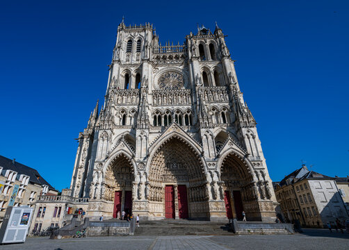 Visitors explore the Cathedral of Amiens, a UNESCO World Heritage site in France, showcasing detailed architecture and historical significance