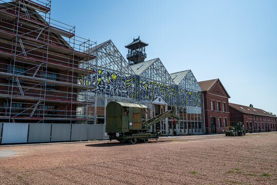 Restoration work and vehicles at Calais Mining Basin Lewarde site in France showcasing industrial heritage