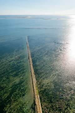 Walkway guiding to the historic lighthouse of Cordouan during low tide in France