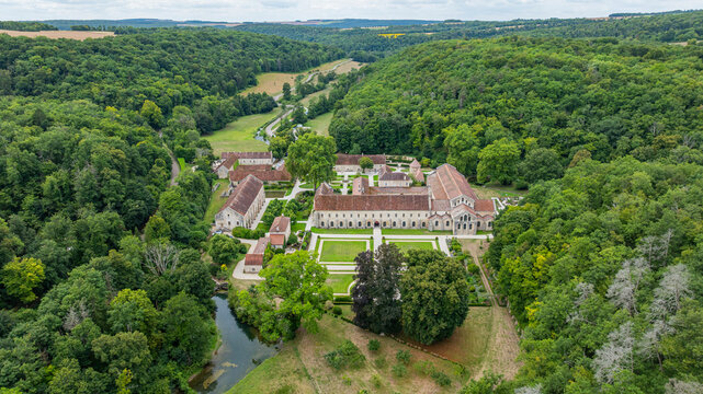 Aerial view of Abbey of Fontenay showcasing its structures and surrounding forest in France