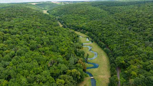 Snaking river winding through green landscape around an important historical site in France