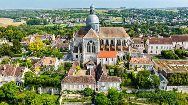 Aerial view showcasing St. Quiriacus church in Provins, surrounded by historic buildings and green landscapes in France