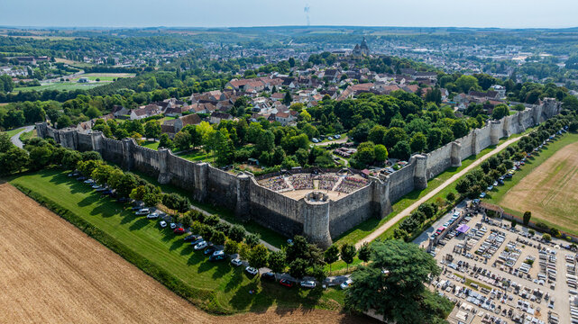 Overview of medieval town of Provins in France with historic walls and green areas around the buildings and fields