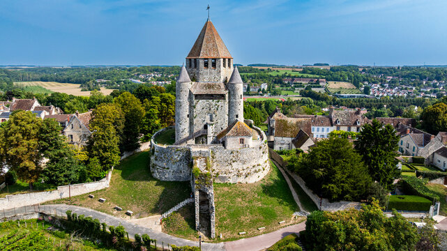 Cesar tower stands tall amid green fields and historic buildings in Provins, France