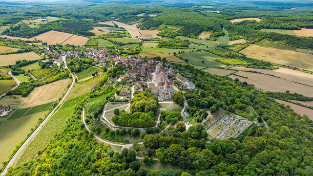 View of Vezelay and its Abbey from above showcasing historical architecture in a lush landscape in France