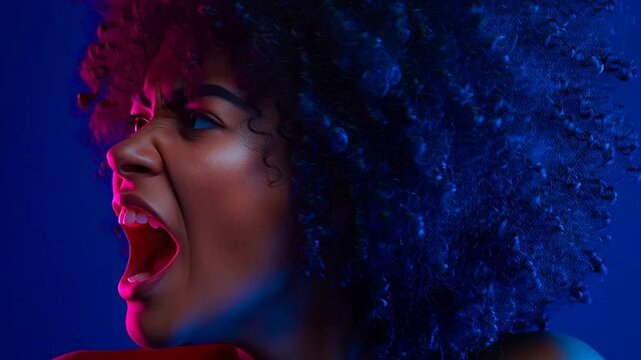 Woman Screaming in Neon Light Expressing Intense Emotion.