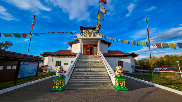 Buddhist Tsechenling Temple located in Kyzyl, Republic of Tuva, Russia with colorful flags and lion statues at entrance