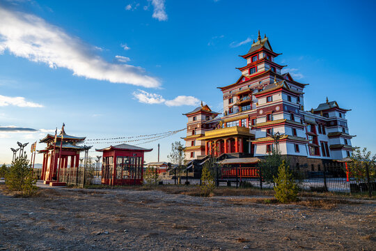 Buddhist temple stands in Kyzyl under blue skies and natural surroundings in the Republic of Tuva, Russia with prayer flags fluttering