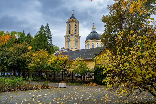 View of Cathedral of St. Peter and St. Paul in Gomel, Belarus during autumn with yellow leaves and cloudy sky